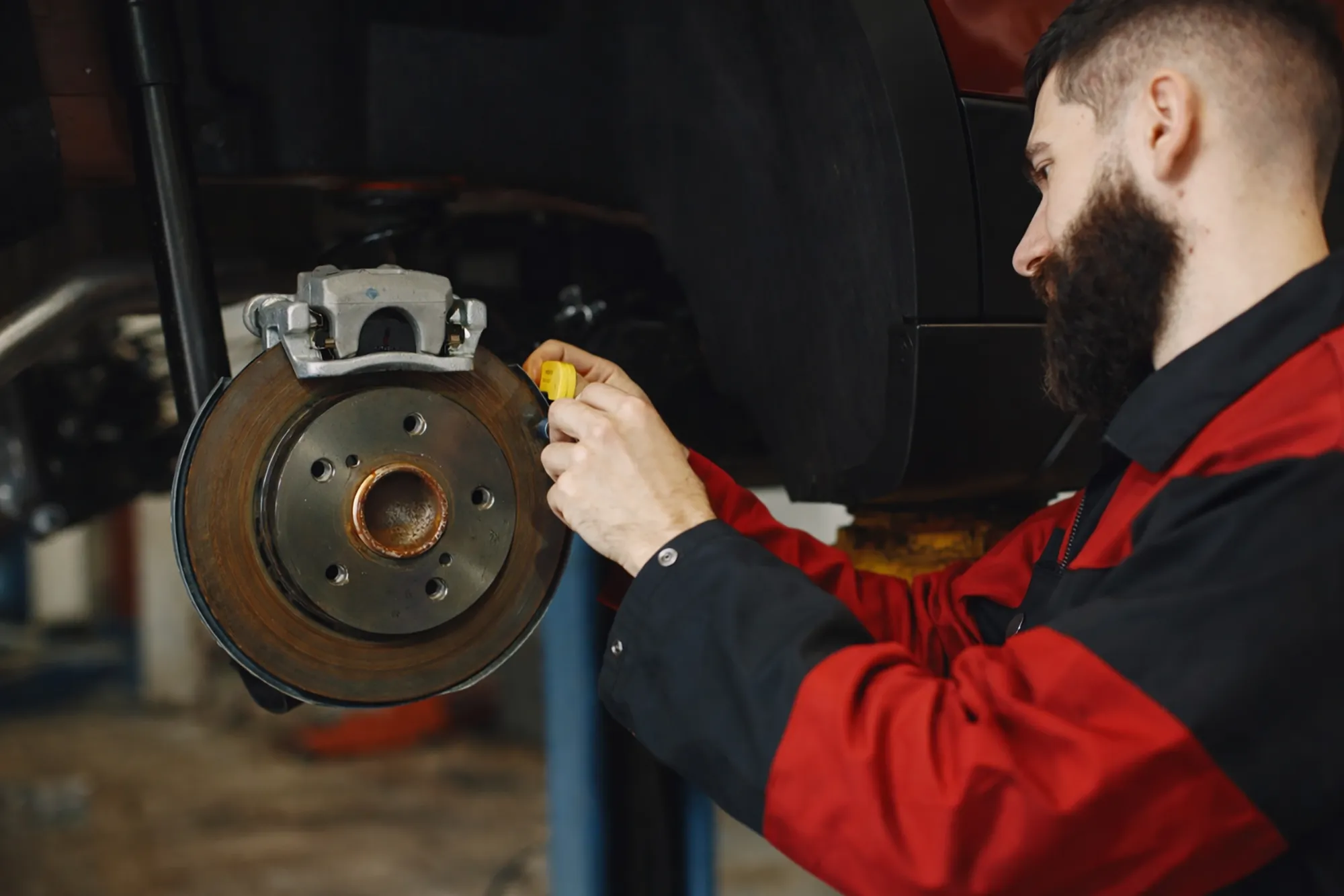 Technician inspecting brake discs at Royal Automotive in Epping