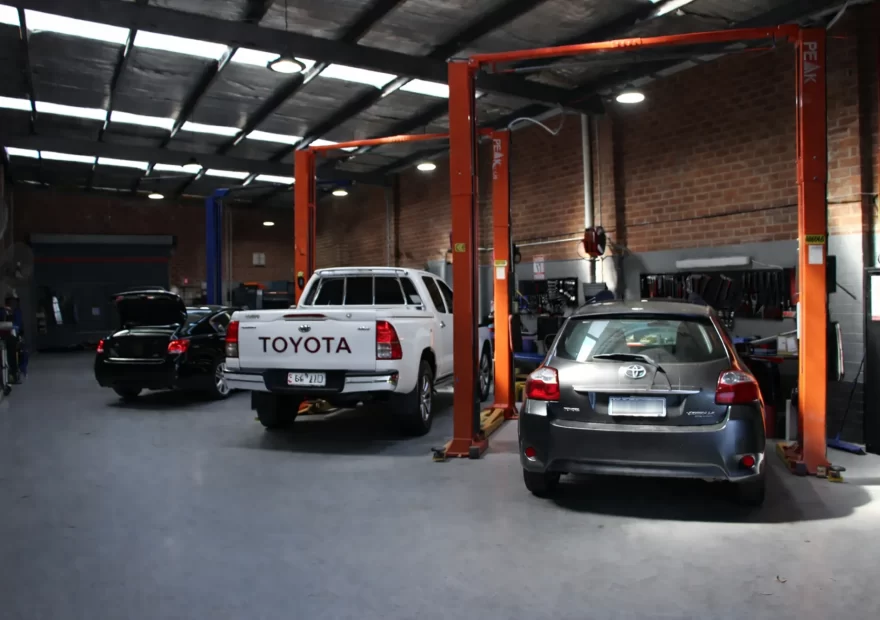 Cars on the hoist in the Royal Automotive workshop during a car service in Epping